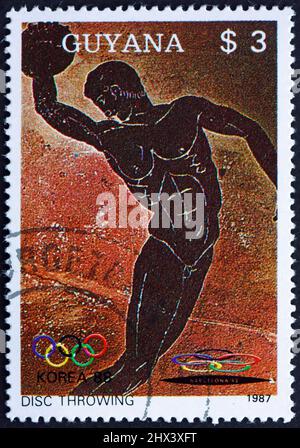 GUYANA - CIRCA 1987: Un francobollo stampato in Guyana mostra discus, sport, 1988 Olimpiadi estive, Seul, circa 1987 Foto Stock