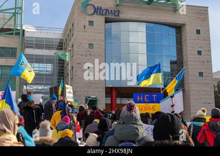 Ottawa, Canada - 27 febbraio 2022: Rally con bandiere ucraine a sostegno dell'Ucraina contro la guerra. Protesta nei pressi del municipio di Ottawa contro gli invasi russi Foto Stock