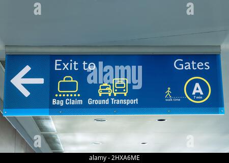 Cartello dell'aeroporto internazionale uscita per Ground Transportation Baggage Claim Gates A in Air Terminal Foto Stock