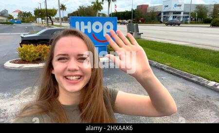 Happy girl prende un selfie a IHOP Miami - MIAMI, STATI UNITI - 20 FEBBRAIO 2022 Foto Stock