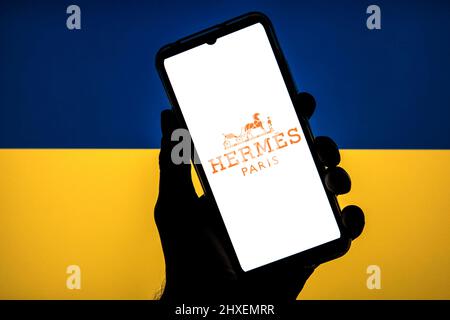 Barcellona, Catalogna. 11th Mar 2022. In questa foto è raffigurato un logo Hermes visualizzato su uno smartphone con una bandiera dell'Ucraina sullo sfondo. (Credit Image: © Thiago Prudencio/DAX via ZUMA Press Wire) Foto Stock