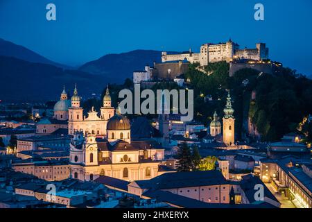 La vista dall'alto è fantastica in una città serale che splende dalle luci. Scena drammatica. Posizione luogo famoso (patrimonio dell'umanità dell'unesco) Festung Hohensalzburg, Salz Foto Stock