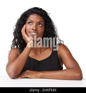 Perso nel pensiero. Studio girato di una donna indiana guardando verso l'alto. Foto Stock