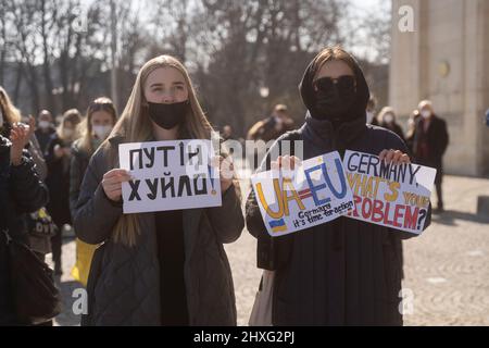 Partecipanti con i segni „UA=UE Germania è il momento di agire“ e „Germania qual è il vostro problema“. Il 12 marzo 2022, centinaia di persone si sono riunite nella Koenigsplatz di Monaco di Baviera, in Germania, per dimostrare la loro solidarietà con l'Ucraina. I manifestanti hanno chiesto il ritiro immediato delle truppe russe, una soluzione politica al conflitto, il sostegno del governo tedesco e sanzioni immediate contro la Russia. (Foto di Alexander Pohl/Sipa USA) Foto Stock