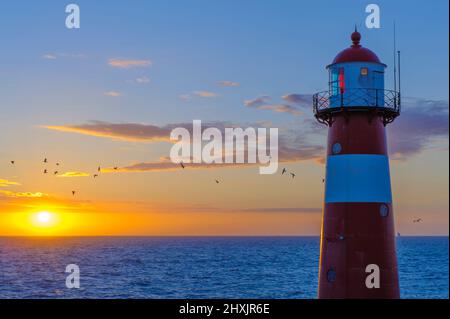 Tramonto al faro 'Noorderhoofd' di Westkapelle, Zeeland, Paesi Bassi Foto Stock