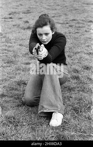 Capo istruttore, Sergente Ivor Montgomery, addestrando le donne della polizia sul poligono di fuoco a Fingringhoe, Essex. Nella foto, WPC Elizabeth Jenkin, 25 anni, punta sul poligono di tiro con il suo revolver. 28th aprile 1977. Foto Stock