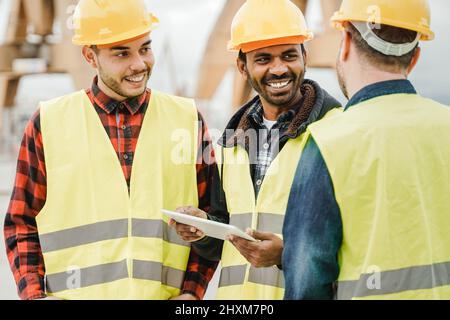 Lavoratori di ingegneria multirazziale che lavorano in cantiere utilizzando un computer tablet - Focus on indian man face Foto Stock