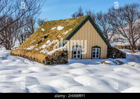 Hofskirkja, una chiesa con tetto in erba sintetica in Islanda durante l'inverno Foto Stock