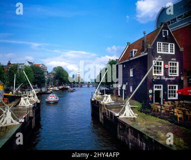 Amsterdam Holland Cafe De Sluyswacht 17th Century Lockhouse ora una caffetteria famosa per Leaning al canale Sint Antoniesluis Oudeschans e. Foto Stock
