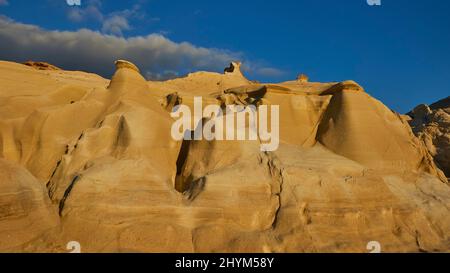 Atmosfera serale, tufo rock, bizzarre formazioni rocciose, azzurro cielo, nuvola grigio-bianca, Baia di Sarakiniko, Isola di Milos, Cicladi, Grecia Foto Stock