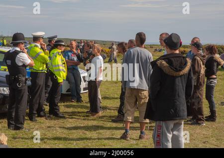 Polizia di fronte a ravers, rave illegale, Dale Airfield, maggio 2010, Pembrokeshire, Galles, Regno Unito, Europa Foto Stock