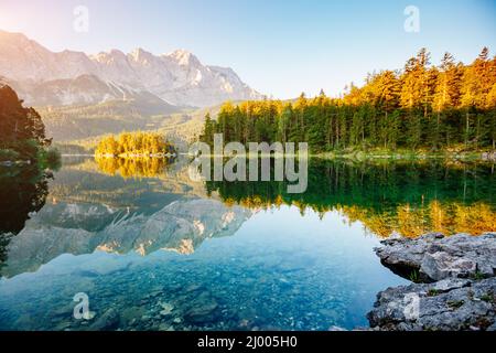 Un'occhiata al famoso lago Eibsee all'alba. Giornata pittoresca scena splendida. Location resort Garmisch-Partenkirchen Bavarian alp, turismo d'Europa. Foto Stock