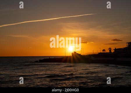 Bellissimo tramonto a Nerja - Malaga - Costa del Sol. Splendidi colori arancioni all'ora d'oro. Sullo sfondo 'Atalaya de la Torrecilla'. Foto Stock