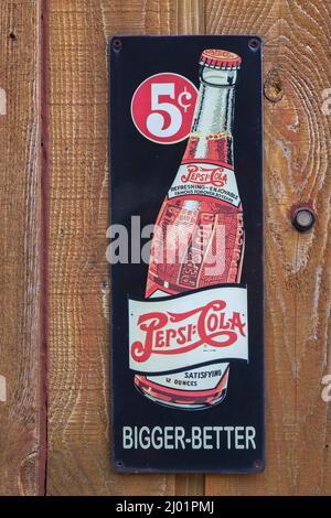 Vecchia Pepsi Cola soft drink società più grande meglio 5 cents bottiglia metallo pubblicità segno pubblicato su rustico legno tavola parete. Foto Stock