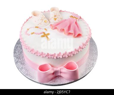 Una torta rosa creativa con un abito a croce e stivali per una bambina di battesimo. Primo piano dall'alto. Foto Stock