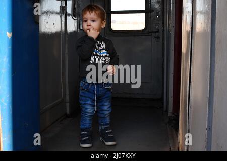 Kramatorsk, Ucraina. 16th Mar 2022. Un ragazzino è in piedi in un vestibolo di carrozza durante l'evacuazione sul treno extra dalla stazione ferroviaria di Kramatorsk. Più di tre milioni di rifugiati hanno lasciato l’Ucraina da quando la Russia ha lanciato la sua invasione su vasta scala nelle prime ore del 24 febbraio. Le persone in fuga sono per lo più donne, bambini e anziani. Credit: SOPA Images Limited/Alamy Live News Foto Stock