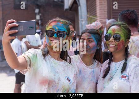 Lalitpur, Nepal. 17th Mar 2022. Le ragazze spalancate in polvere colorata prendono selfie durante la celebrazione di Holi, il festival dei colori, a Lalitpur, Nepal, 17 marzo 2022. Credit: Hari Maharjan/Xinhua/Alamy Live News Foto Stock