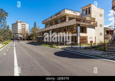 Il distretto di Varosha (Kapalı Maraş) a Famagosta (Cipro) fu tra il 1970 e il 1974 una delle destinazioni turistiche più popolari al mondo. I suoi abitanti greco-ciprioti fuggirono durante l'invasione turca di Cipro nel 1974, quando la città di Famagosta passò sotto il controllo turco. Da allora è rimasto abbandonato e gli edifici sono decaduti. Una manciata di strade all'interno del resort sono state ripavimentate per facilitare l'esplorazione. È anche possibile noleggiare una bicicletta una volta passato attraverso il checkpoint militare – anche se ci sono solo poche strade aperte e la zona è abbastanza piccola da camminare ar Foto Stock