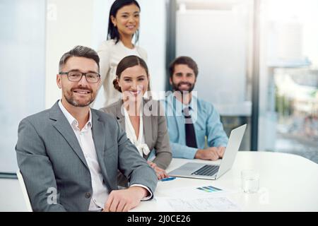 Colletto bianco sicuro. Ritratto di un gruppo di uomini d'affari che lavorano insieme in un ufficio moderno. Foto Stock