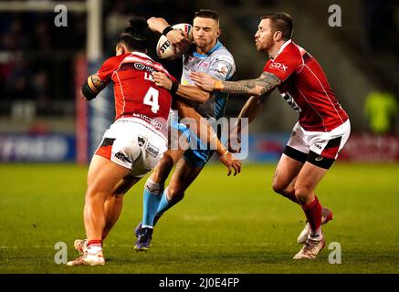 Il Jack Walker di Leeds Rhinos (centro) è affrontato da Tim Lafai di Salford Red Devils (a sinistra) e Marc Sneyd durante la partita della Betfred Super League allo stadio Emerald Headingley di Leeds. Data foto: Venerdì 18 marzo 2022. Foto Stock