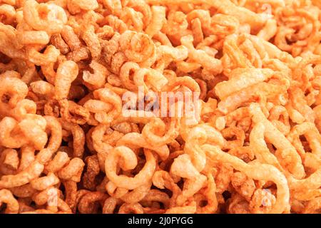 Vista ravvicinata di snack di maiale, scorza di maiale, graffi di maiale, crackling di maiale. Che è crosta di maiale, cuoio o pelle magra di maiale fritto c Foto Stock