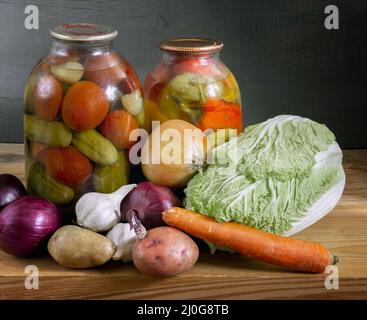 Verdure fresche e in scatola su una mensola di legno Foto Stock