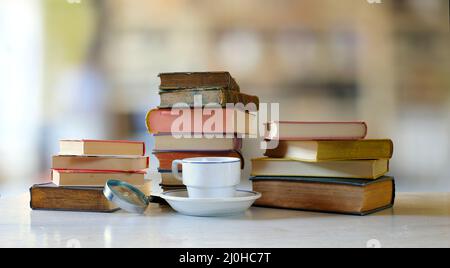 home office, istruzione, business, concetto con un mucchio di libri e tazza di caffè, sfondo sfocato, spazio di copia gratuito Foto Stock