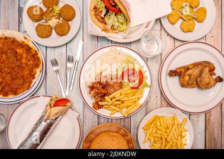 Piatto di kebab con falafel, pollo alla griglia, durum, lahmacun, pepite e kebab sandwich Foto Stock