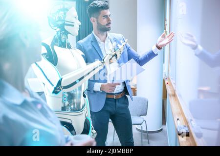 Businessmen with humanoid robot project development Stock Photo