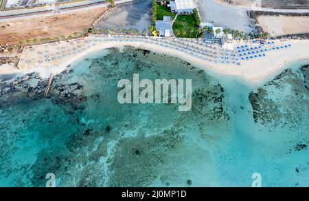 Drone vista dall'alto di una località turistica e costa con acque turchesi del mare. Foto Stock