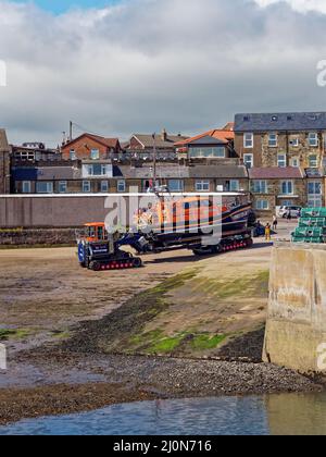 The Shannon Launch and Recovery Vehicle si trova a Low Tide attraverso le sabbie del Seahouses Harbour per il suo lancio. Foto Stock