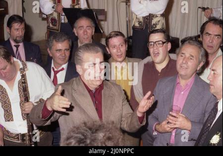 Los Angeles, CA, USA, circa 1989. Il direttore del coro rumeno Marin Constantin con i membri del coro Madrigal che cantano per le persone della comunità rumena. Foto Stock