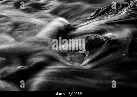 Lunga esposizione di un fiume, bianco e nero. Foto Stock