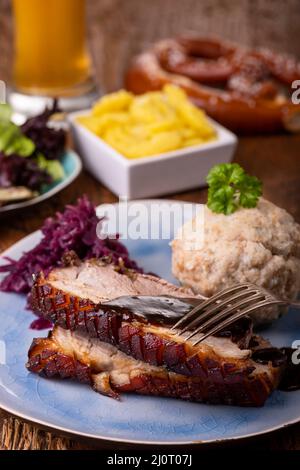 porzione di maiale arrosto fresco su un piatto blu Foto Stock
