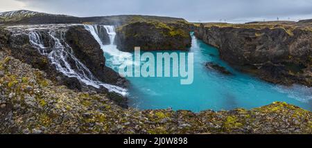Picturesque waterfall Sigoldufoss autumn view. Season changing in southern Highlands of Iceland. Stock Photo