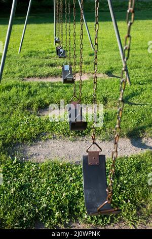 Fila di sedili vuoti per bambini con sistema di oscillazione Foto Stock