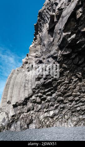 Basalt rock pillars columns at Reynisfjara beach near Vik, South Iceland. Unique geological volcanic formations. Ð¡ave at the fo Stock Photo