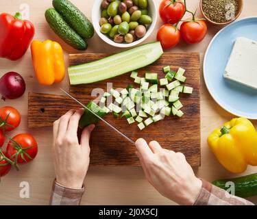 Step by step recipe for salad horiatiki, wooden board for cutting vegetables Stock Photo