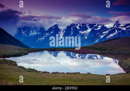 Fantastico paesaggio con lago Koruldi e cielo nuvoloso al piede di Mt. Ushba. Svaneti superiore, Mestia, Georgia, l'Europa. Montagne del Caucaso. Bellezza w Foto Stock