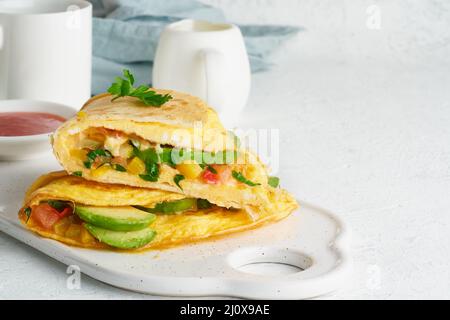 Colazione alla moda con quesadilla e uova, cibo di tendenza con omelette, formaggio Foto Stock