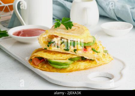 Colazione alla moda con quesadilla e uova, cibo di tendenza con omelette, formaggio Foto Stock