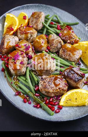 Modern style jusy seared pork pigllet tenderloin fillet meat medallions with orange relish sauce Stock Photo