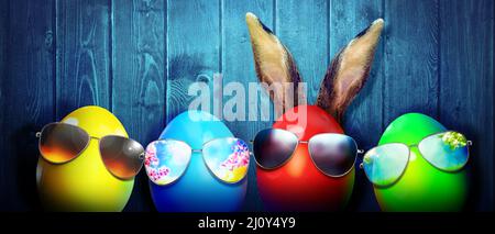 Easter background with colorful easter eggs on wooden background. Stock Photo