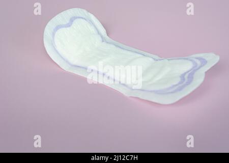 Protezione igienica della donna. Tamponi sanitari su sfondo viola, vista dall'alto, schema dello spazio di copia. Concetto del ciclo mestruale. Foto Stock