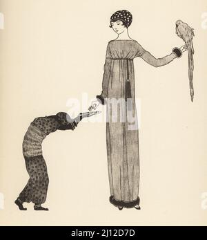 Donna alla moda in berretto e accappatoio dal marchio couture Paul Poiret, 1911. Tiene un pappagallo e prende l'alimentazione dell'uccello da un vassoio Les robes de Paul Poiret, 1911. Litografia di Marcel Bry dopo Georges Lepape di le Costume de la Revolution di Raymonde See a nos Jours, Editions de la Gazette des Beaux-Arts, Parigi, 1929. Foto Stock