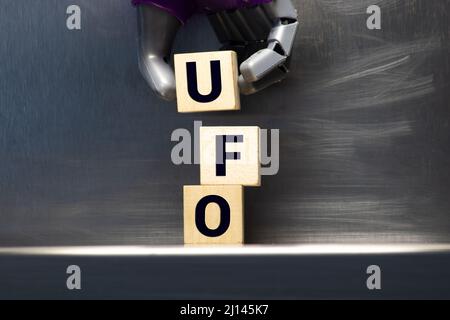 La sigla UFO che sta per un oggetto volante non identificato, farro con lettera in legno piastrelle su uno sfondo bianco. Foto Stock