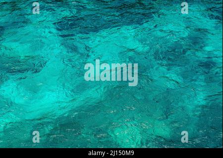 La foto mostra la texture dell'oceano. La superficie del mare è turchese. Ocean Water pattern è chiaro e in diverse sfumature di blu. Lo sfondo dell'acqua di mare è tr Foto Stock