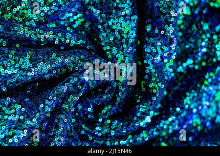 Texture sequins.Green blue sequins background.Shiny blue and green fabric.Handicraft and hobby. Foto Stock