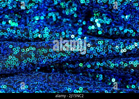 Texture sequins.Green blue sequins background.Shiny blue and green fabric.Handicraft and hobby. Tessendo con paillettes. Foto Stock