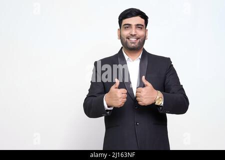 Uomo ispanico adulto su sfondo isolato facendo i pollici felici su gesto con la mano. Foto Stock